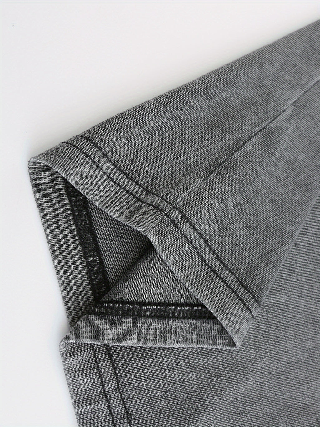 Close-up of soft, dark gray fabric with a slight stretch, perfect for casual wear and t-shirts.