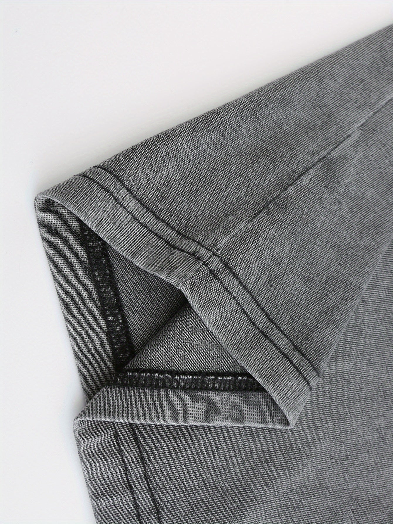 Close-up of soft, dark gray fabric with a slight stretch, perfect for casual wear and t-shirts.