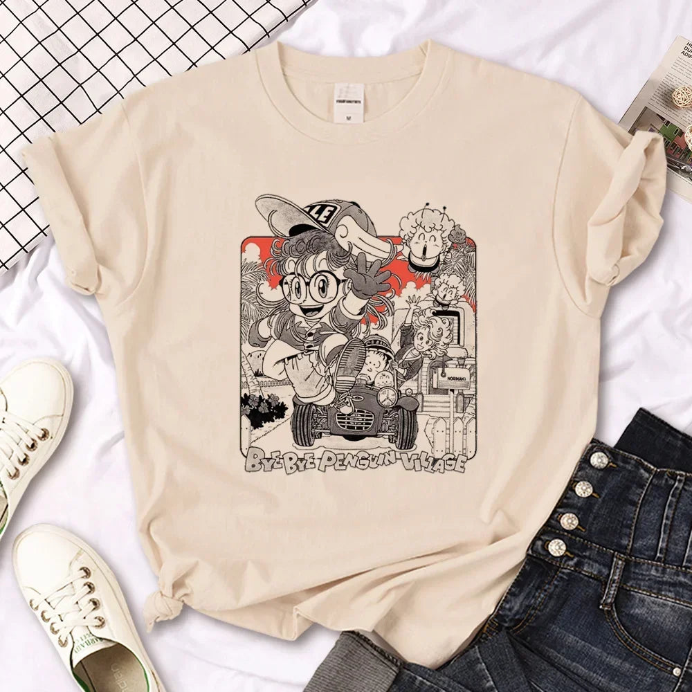 Anime-inspired beige t-shirt featuring a character with glasses and a cap, surrounded by cute graphics and vibrant designs.