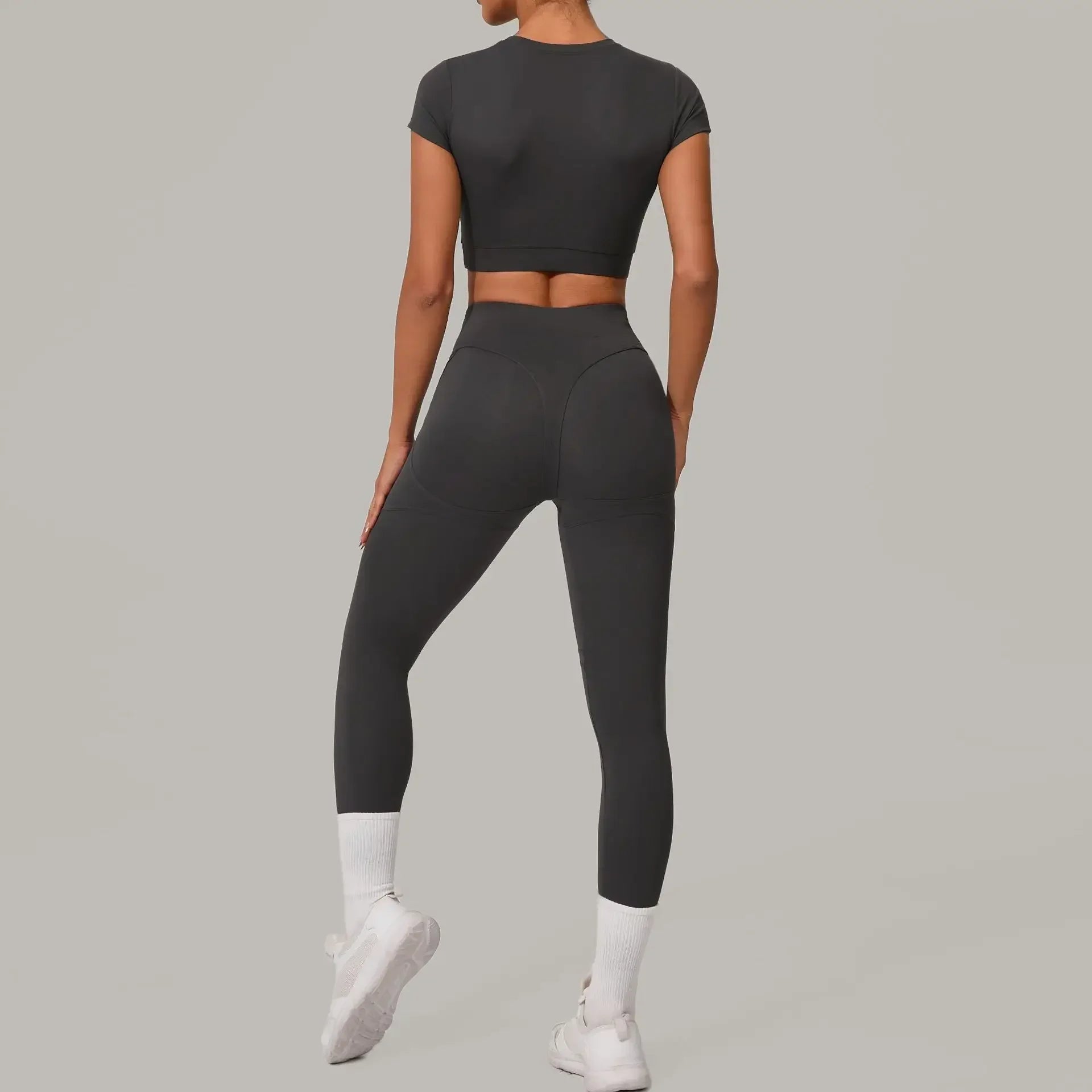 Women wearing seamless yoga sets in brown and beige, showcasing high waist and hip lift design, perfect for fitness activities.
