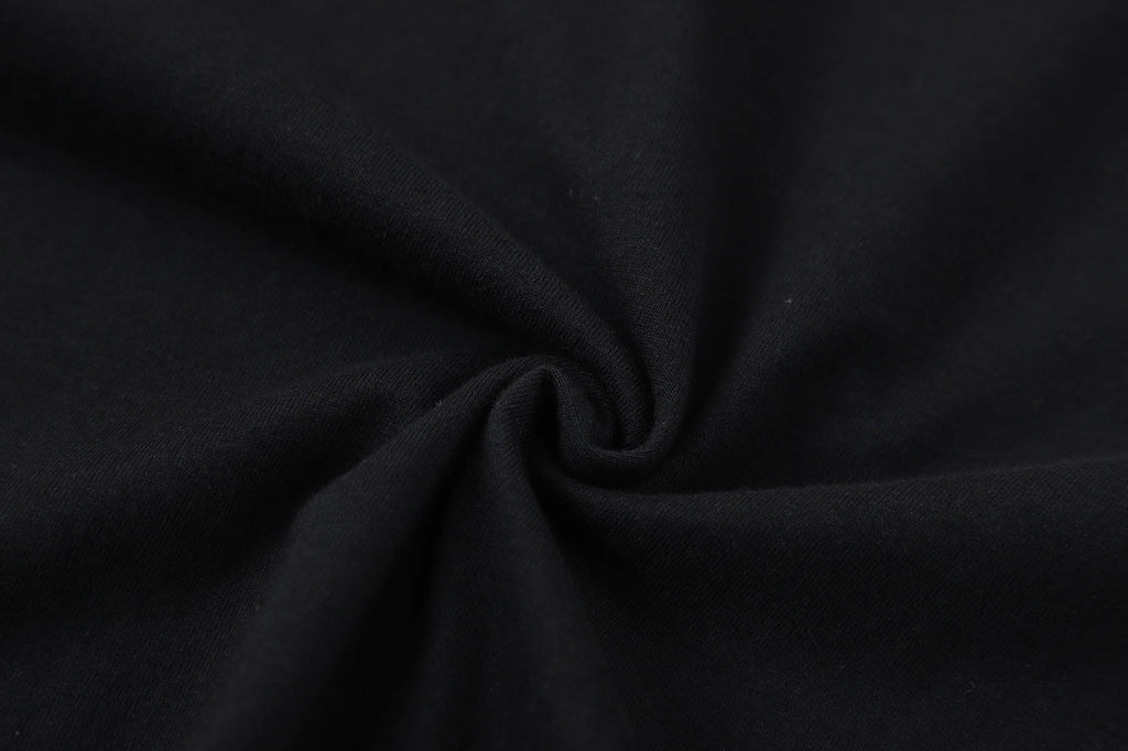 Close-up of black cotton fabric, showcasing soft and smooth texture suitable for T-shirt designs.
