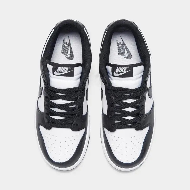Women's Nike Dunk Low Retro shoes in black and white, featuring a sleek design and casual style.