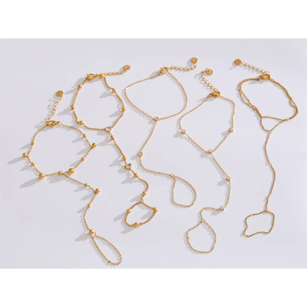 Collection of trendy gold link chain bracelets with decorative beads and unique designs on a white background.