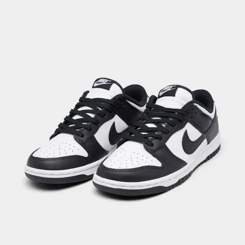 Women's Nike Dunk Low Retro shoes in black and white, featuring a sleek design and casual style.