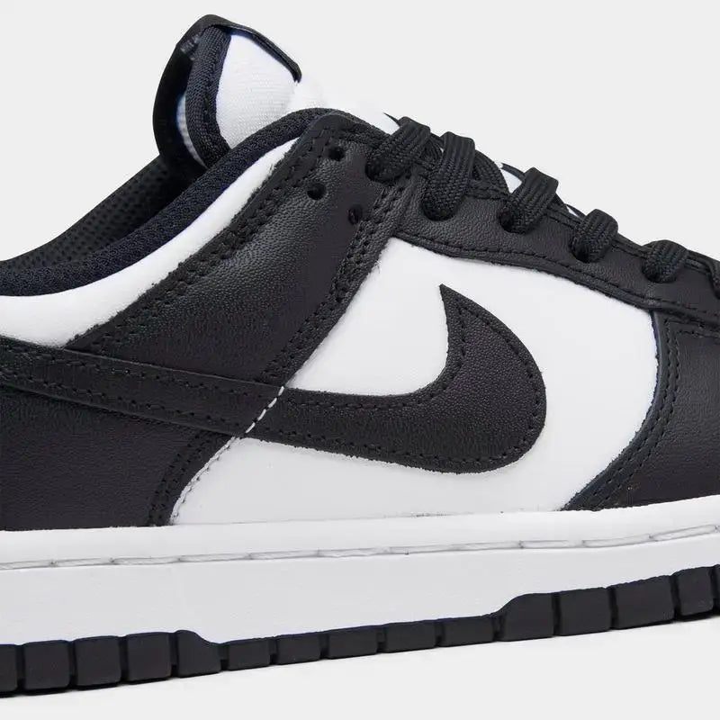 Women's Nike Dunk Low Retro shoes in black and white, featuring a sleek design and casual style.
