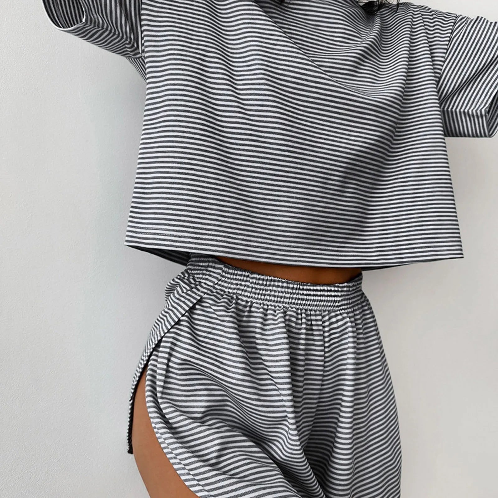 Women's striped pajama set with short sleeve t-shirt and elastic waistband shorts in comfortable fabric.