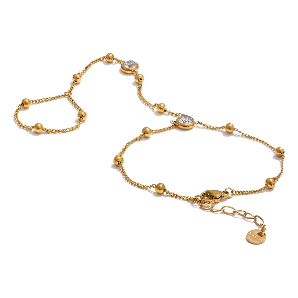 Trendy gold stainless steel charm bracelet with zircon beads and link chain design.