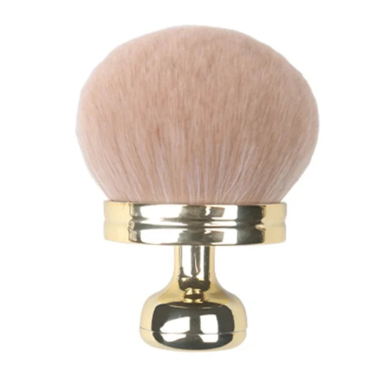 Close-up of a hand holding a fluffy extra large body makeup brush with a gold cap, perfect for applying makeup.