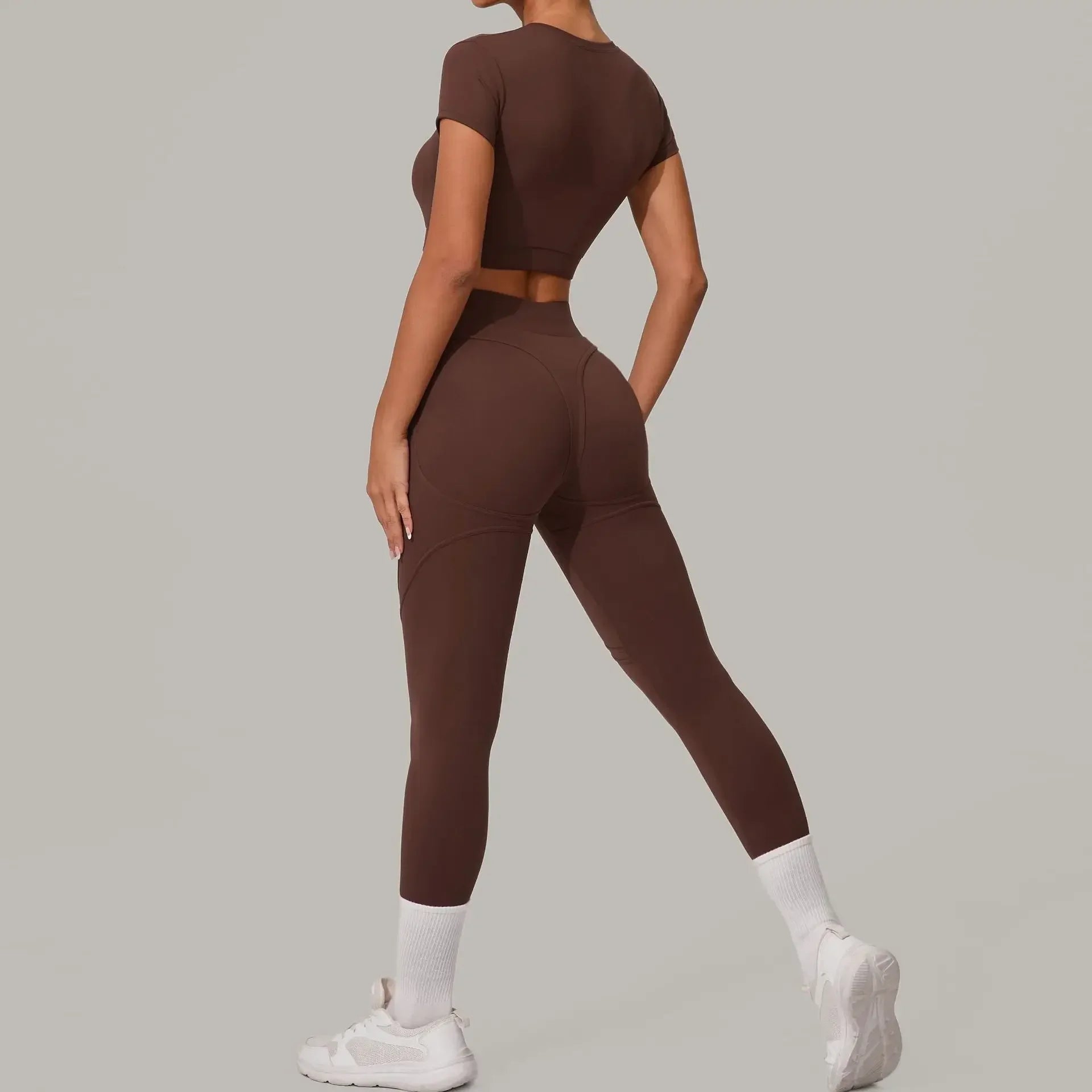 Women wearing seamless yoga sets in brown and beige, showcasing high waist and hip lift design, perfect for fitness activities.
