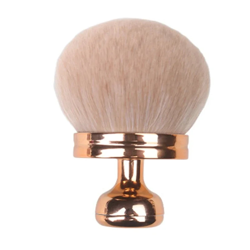Close-up of a hand holding a fluffy extra large body makeup brush with a gold cap, perfect for applying makeup.