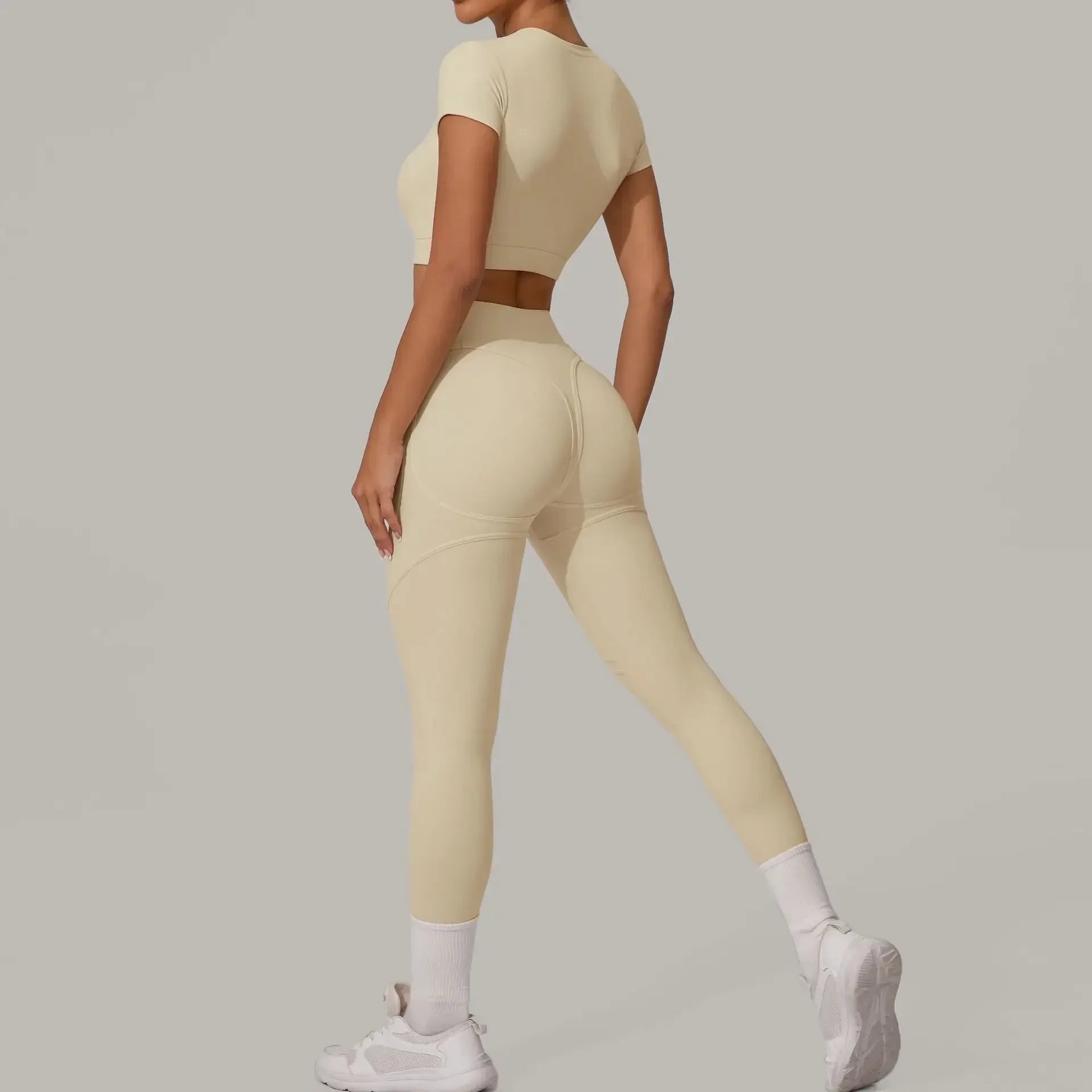 Women wearing seamless yoga sets in brown and beige, showcasing high waist and hip lift design, perfect for fitness activities.