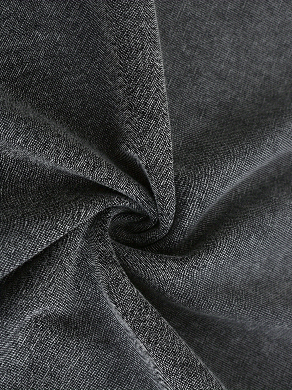 Close-up of soft, dark gray fabric with a slight stretch, perfect for casual wear and t-shirts.
