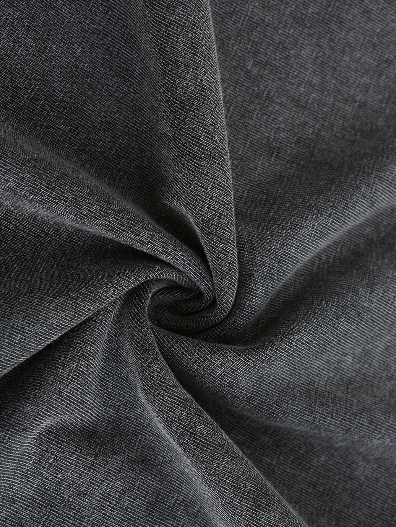 Close-up of soft, dark gray fabric with a slight stretch, perfect for casual wear and t-shirts.