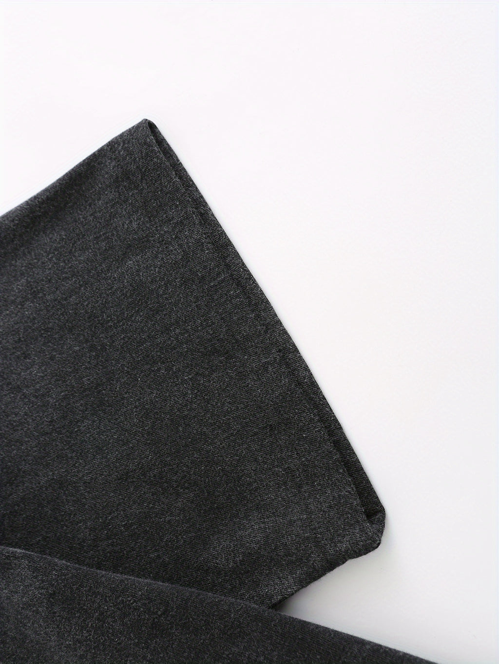 Close-up of soft, dark gray fabric with a slight stretch, perfect for casual wear and t-shirts.