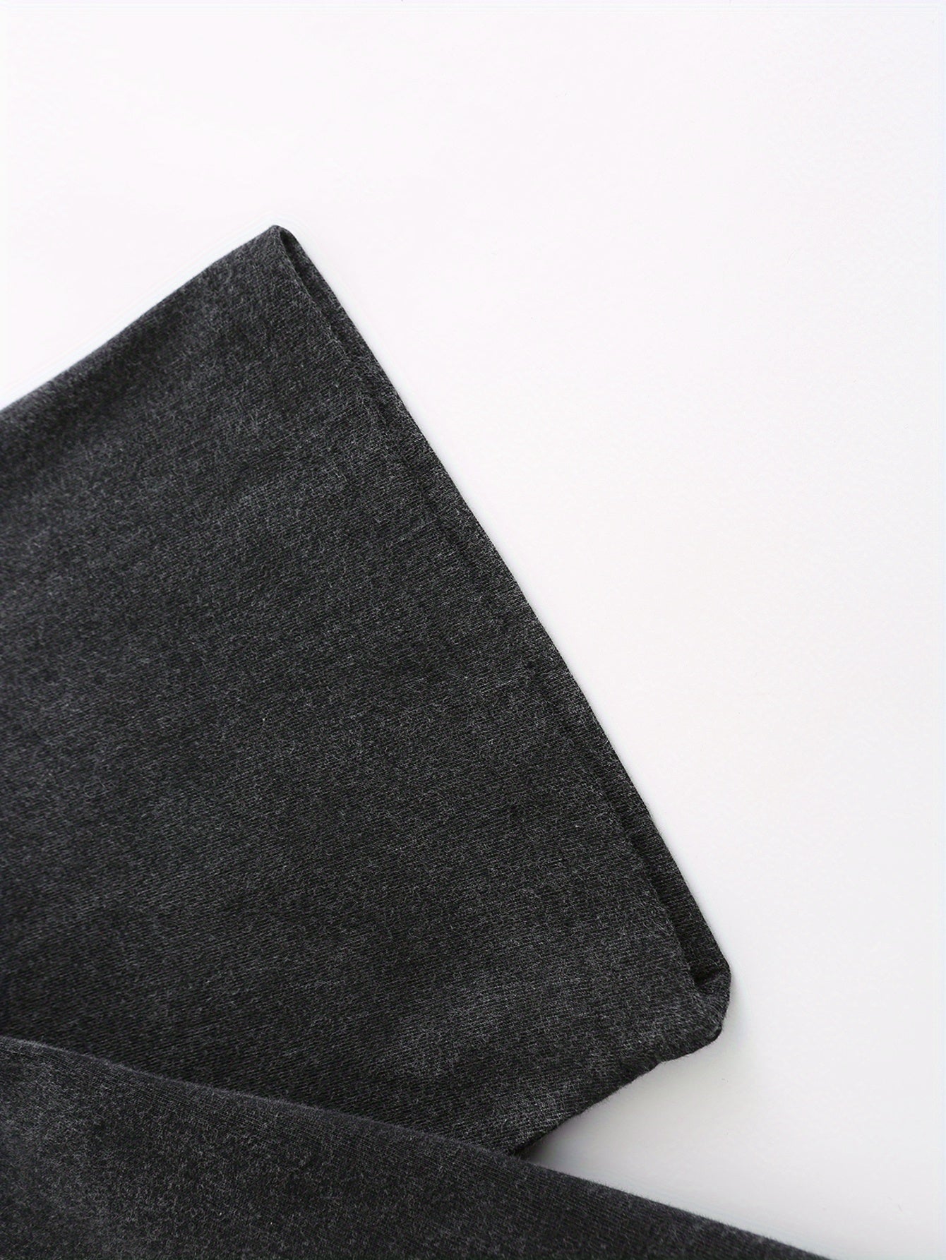 Close-up of soft, dark gray fabric with a slight stretch, perfect for casual wear and t-shirts.