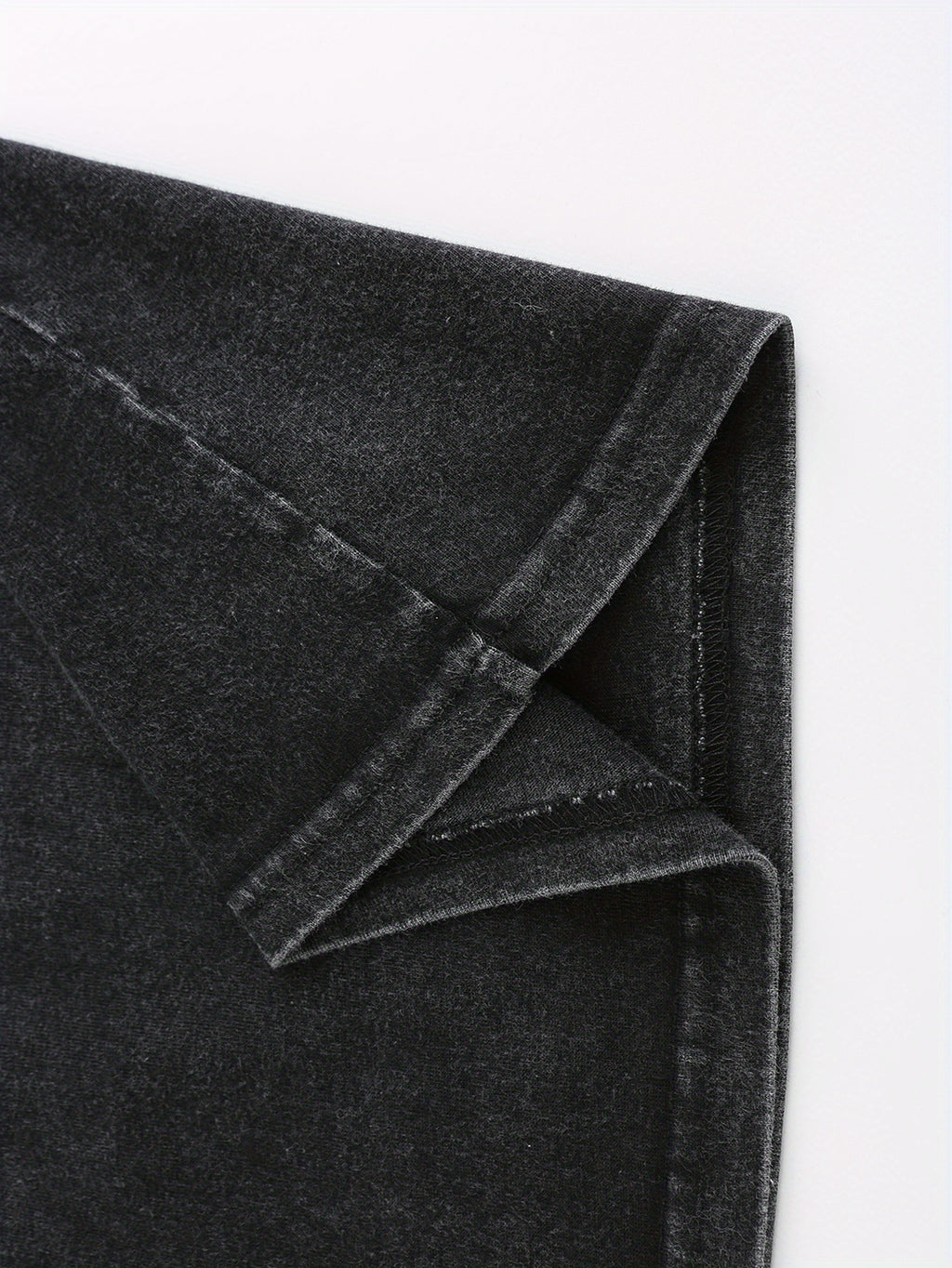 Close-up of soft, dark gray fabric with a slight stretch, perfect for casual wear and t-shirts.