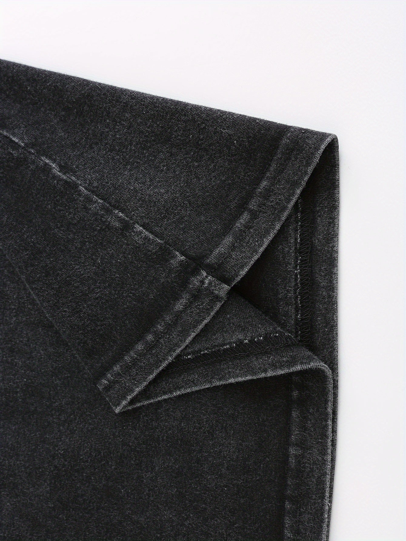 Close-up of soft, dark gray fabric with a slight stretch, perfect for casual wear and t-shirts.